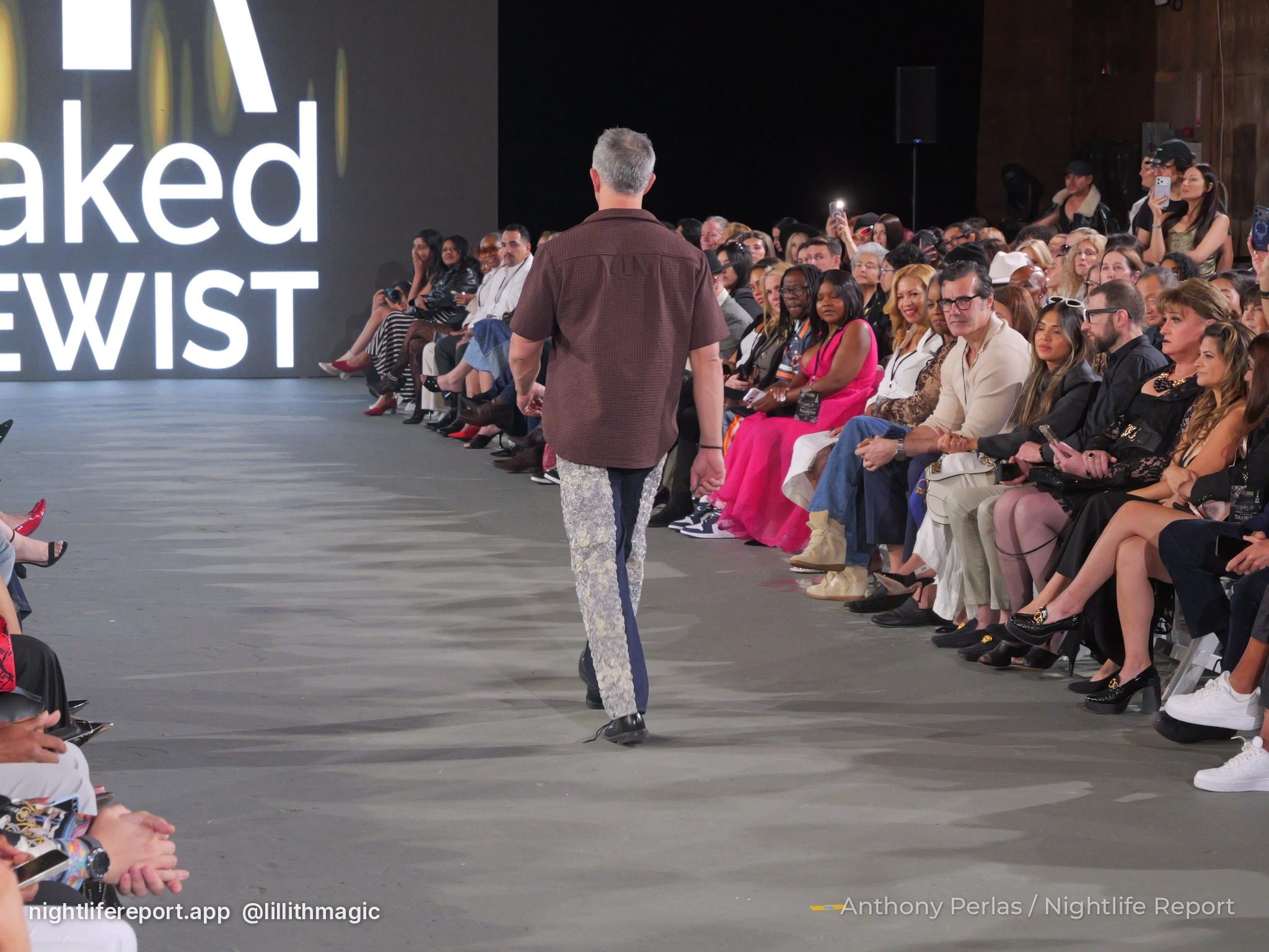 Runway look by Naked Sewist (Doug Chinery) at The Bureau Fashion Week LA, The Finale: rear view of the brown shirt and panelled navy and silver trousers.