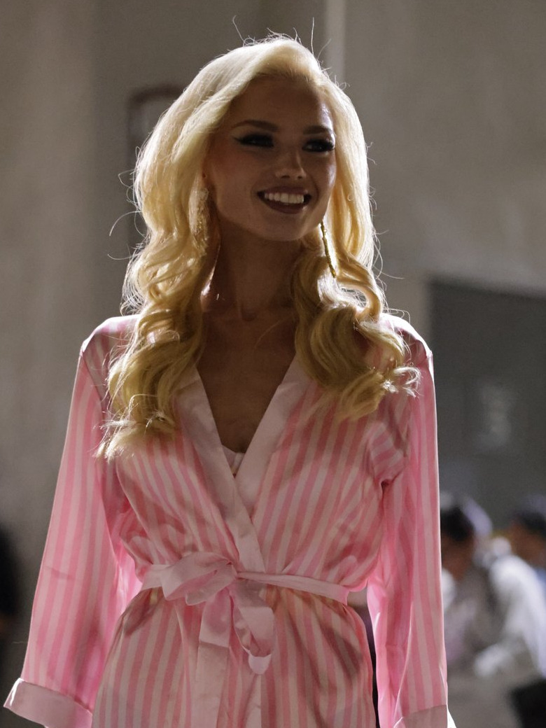 Emily Sophie Christine smiling backstage at The Bureau Fashion Week LA in a pink striped robe