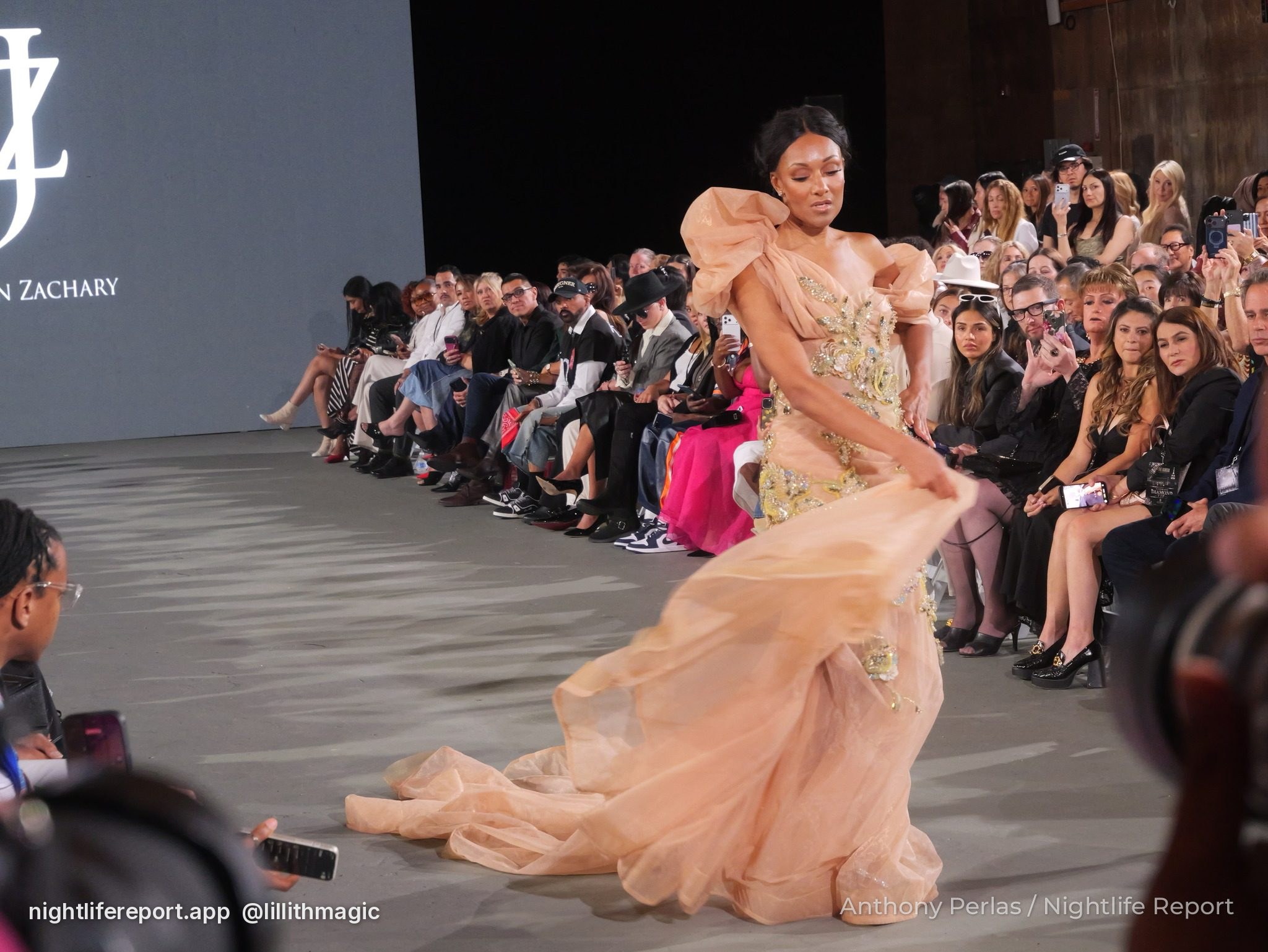 Runway look by Justin Zachary at The Bureau Fashion Week LA, The Finale: peach tulle gown with sculpted ruffled shoulders and a sweeping train.