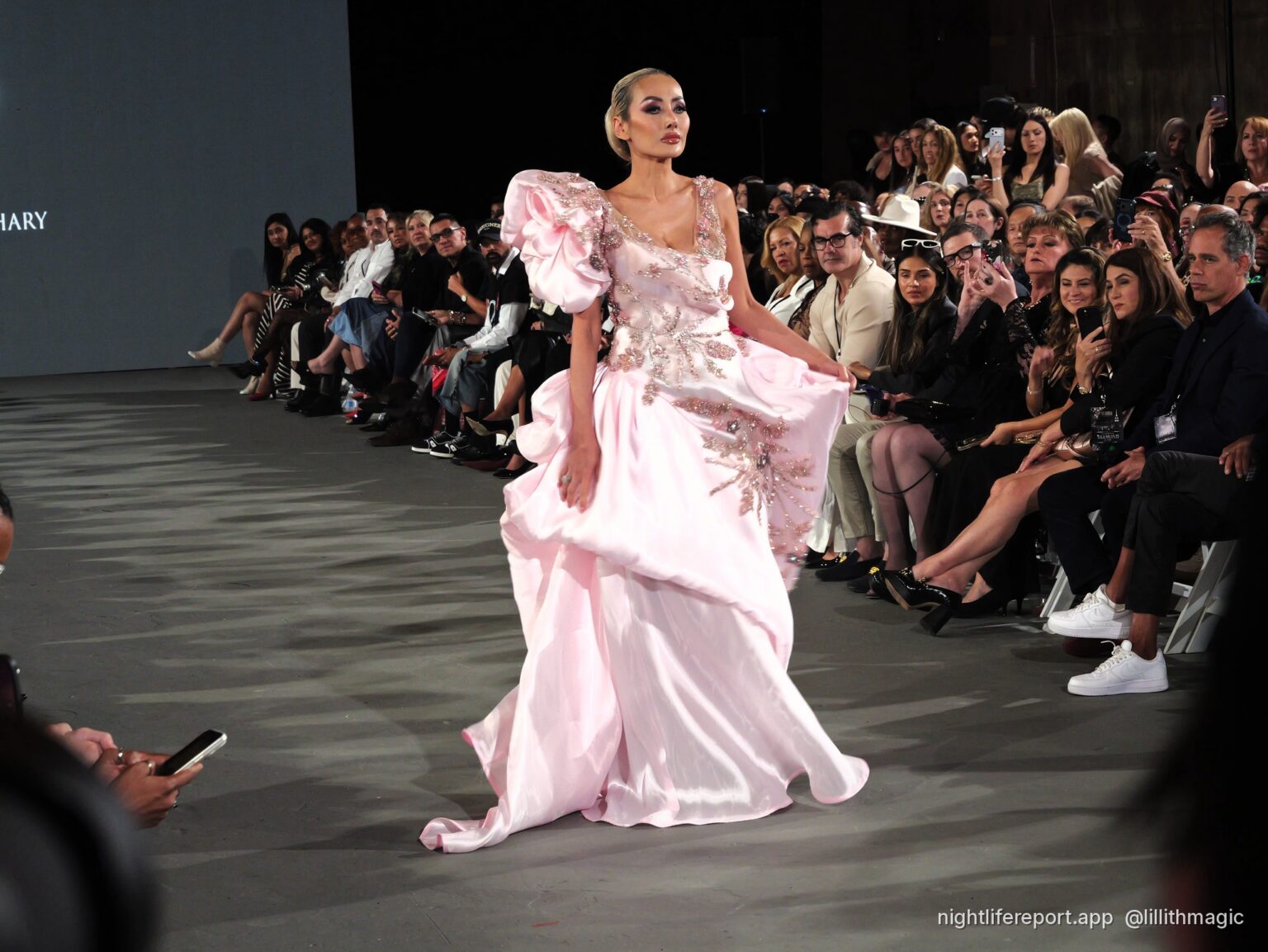 Mirka Howard (@mirhoward28) walks Justin Zachary Look 13, a blush floral-embroidered gown with a ruffled shoulder, at The Bureau Fashion Week LA, Day 2, The Finale, Sat Oct 17, 2026 (frame P1000966). Photo: Anthony Perlas / nightlifereport.app