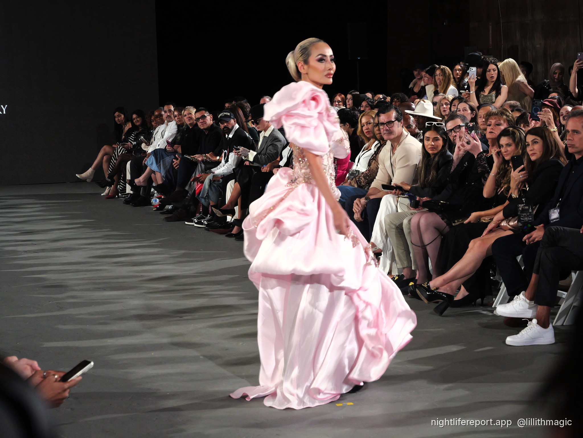 Mirka Howard (@mirhoward28) walks Justin Zachary Look 13, a blush floral-embroidered gown with a ruffled shoulder, at The Bureau Fashion Week LA, Day 2, The Finale, Sat Oct 17, 2026 (frame P1000967). Photo: Anthony Perlas / nightlifereport.app