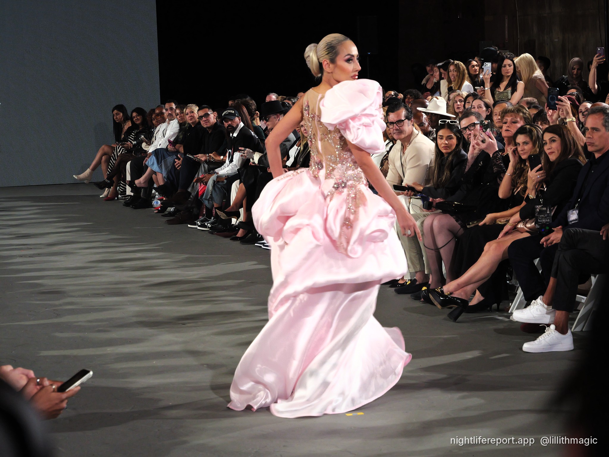 Mirka Howard (@mirhoward28) walks Justin Zachary Look 13, a blush floral-embroidered gown with a ruffled shoulder, at The Bureau Fashion Week LA, Day 2, The Finale, Sat Oct 17, 2026 (frame P1000968). Photo: Anthony Perlas / nightlifereport.app