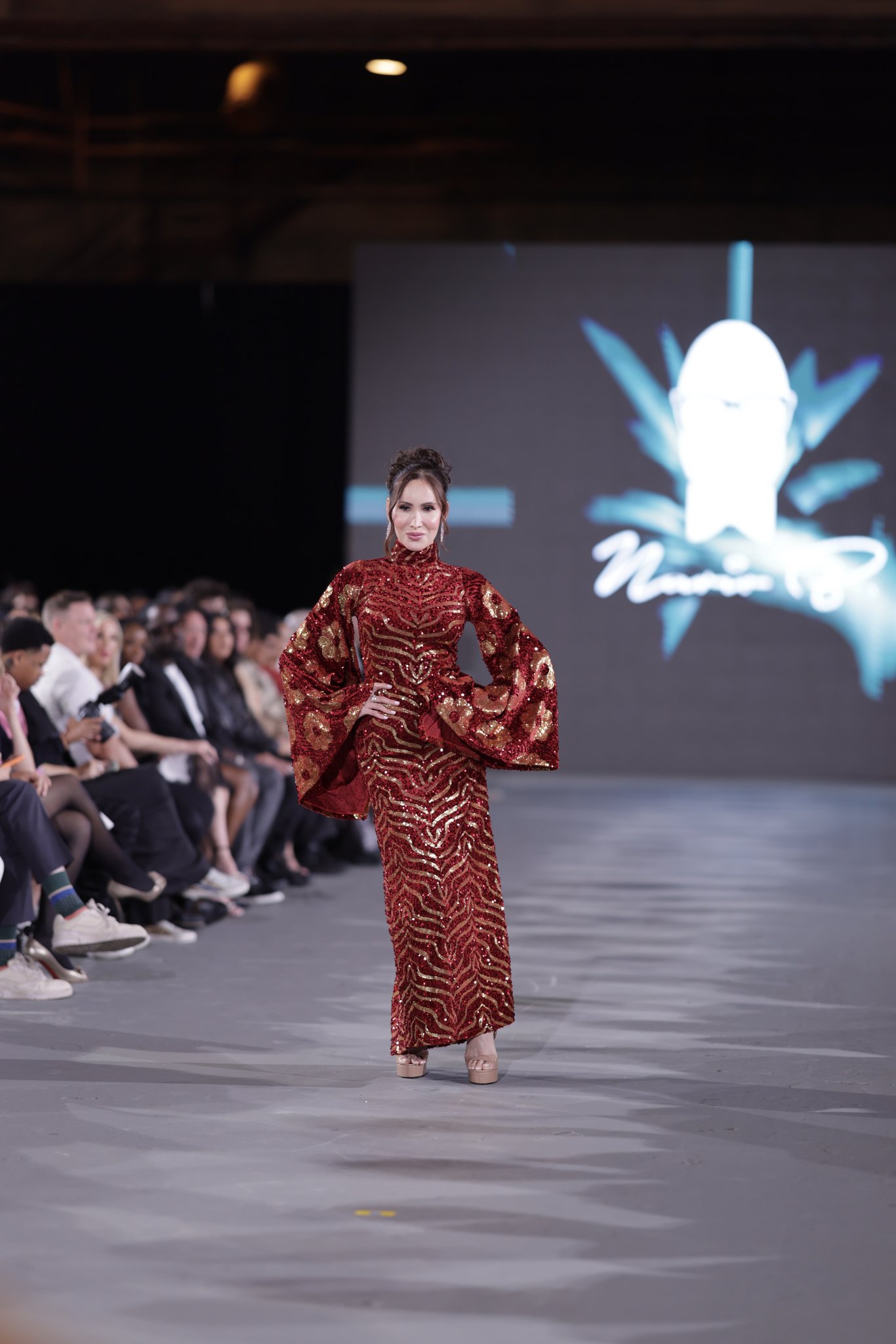 Nicole Anne Williams on the runway in a red gown