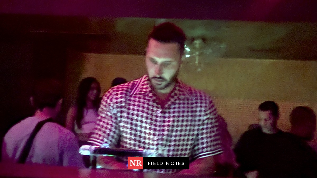 A DJ at Zouk under red light, in a still from Anthony Perlas's video