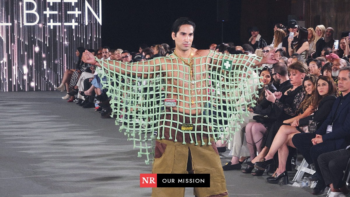 A model walks the runway past a full front row at The Bureau Fashion Week LA, October 2026